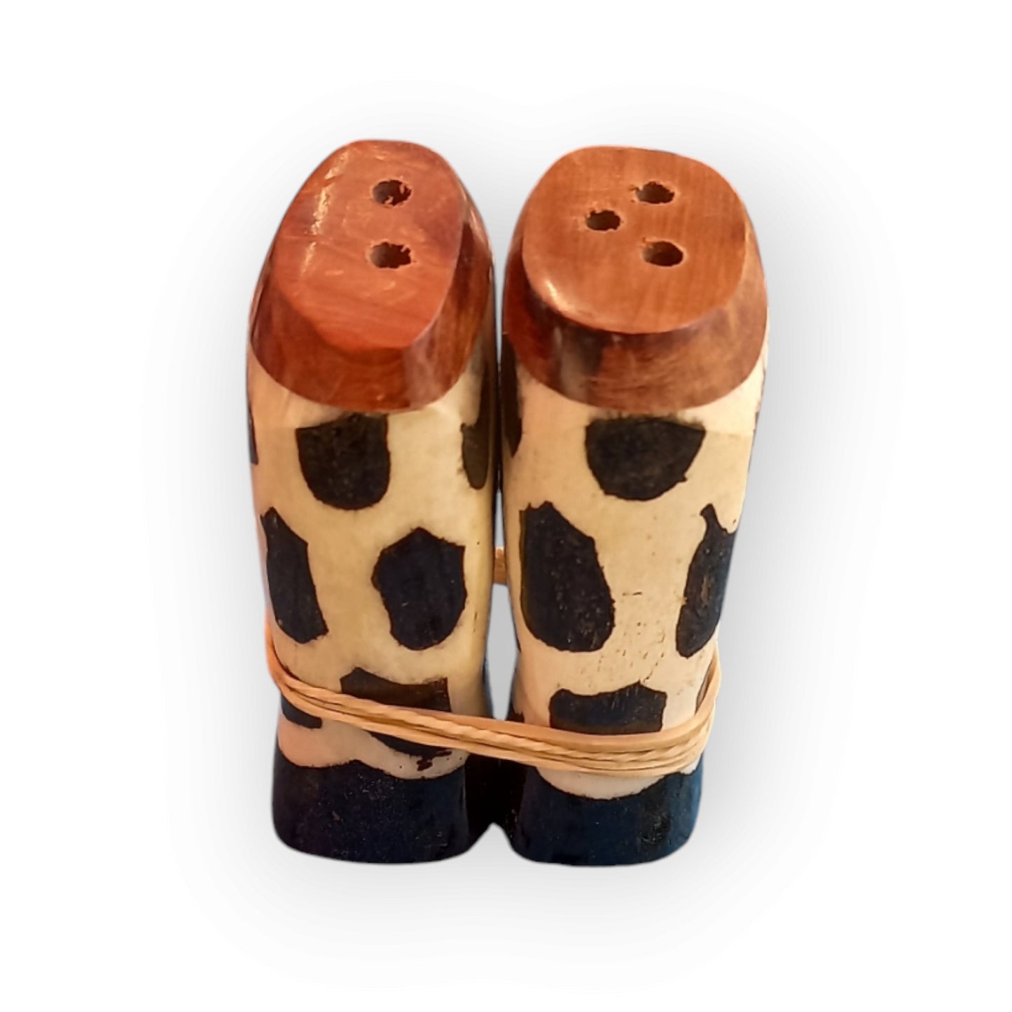 a pair of white and black cow bone salt &pepper shakers. Handmade in Kenya 