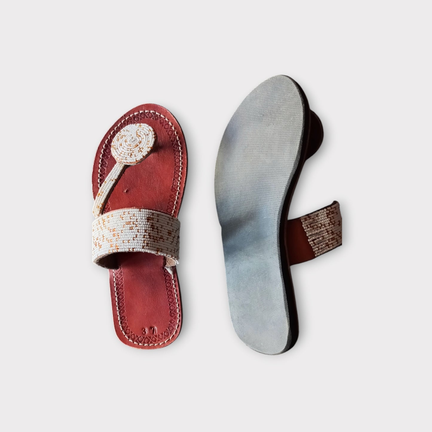 a pair of leather beaded toe-ring Maasai sandals 