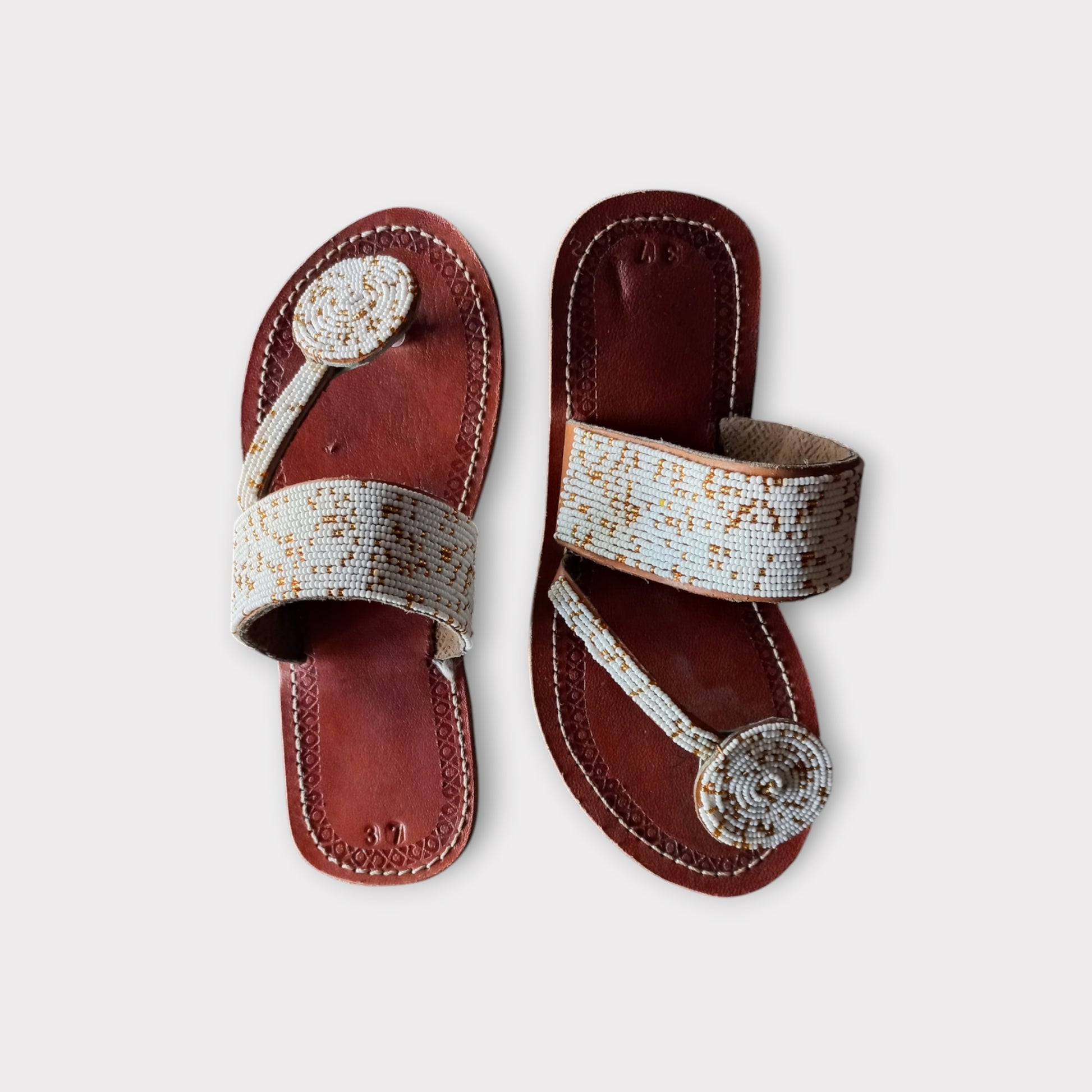 a pair of leather beaded toe-ring sandals 