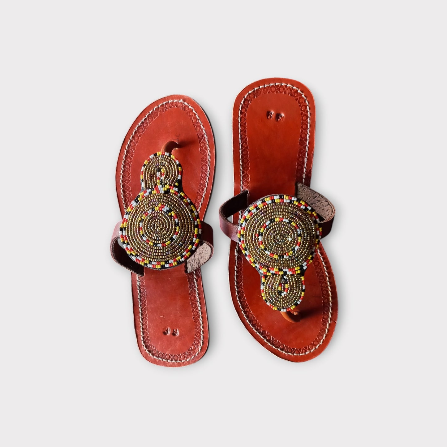 Pair of Maasai leather sandals with colorful beadwork
