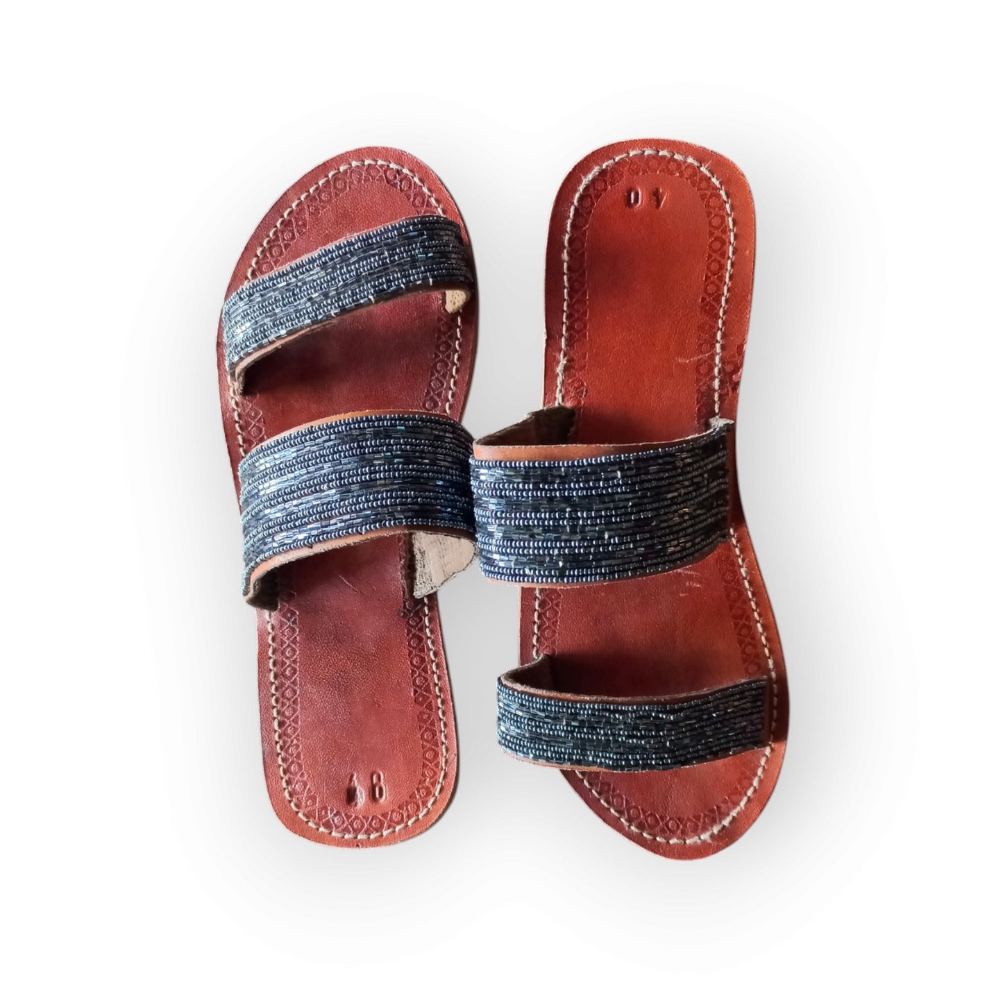 Pair of Maasai leather sandals with colorful beadwork
