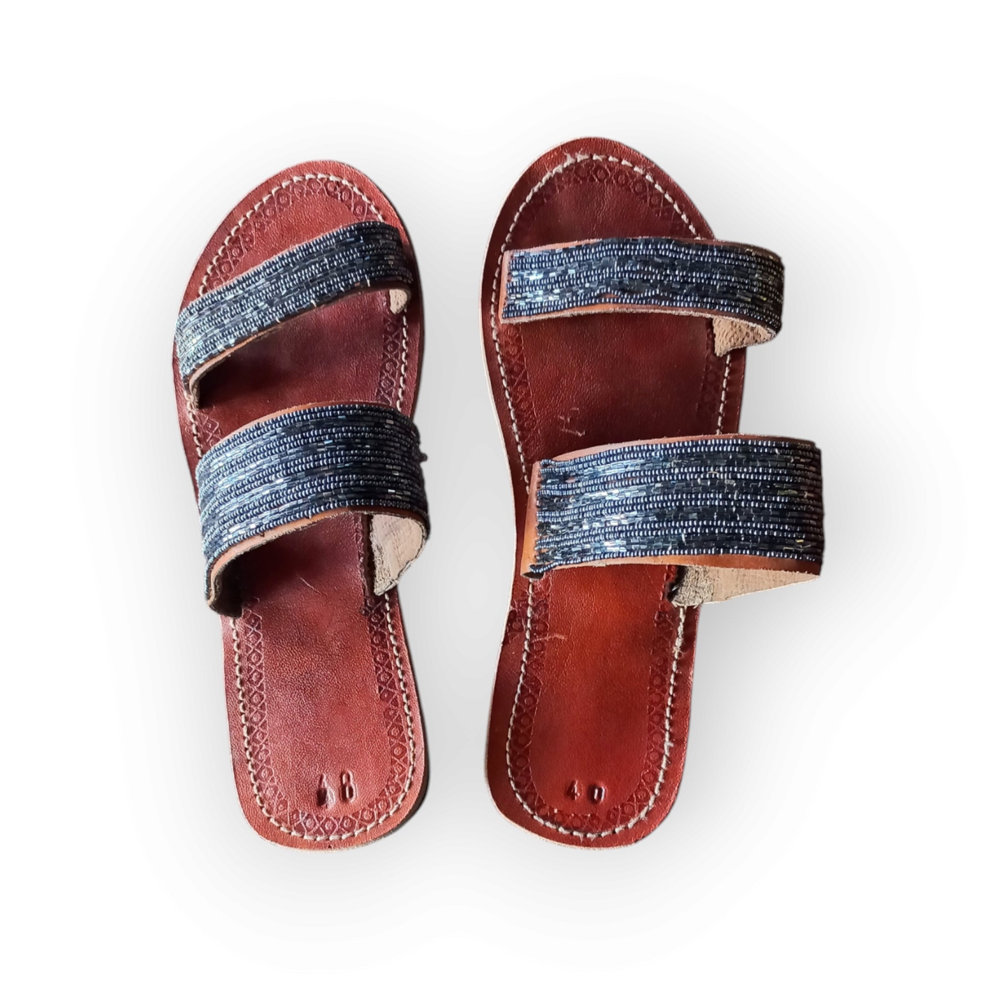 Pair of Maasai leather sandals with colorful beadwork
