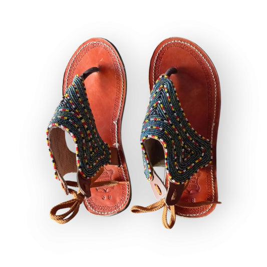 Handmade Maasai sandals with colorful beading and leather straps, made in Kenya.
