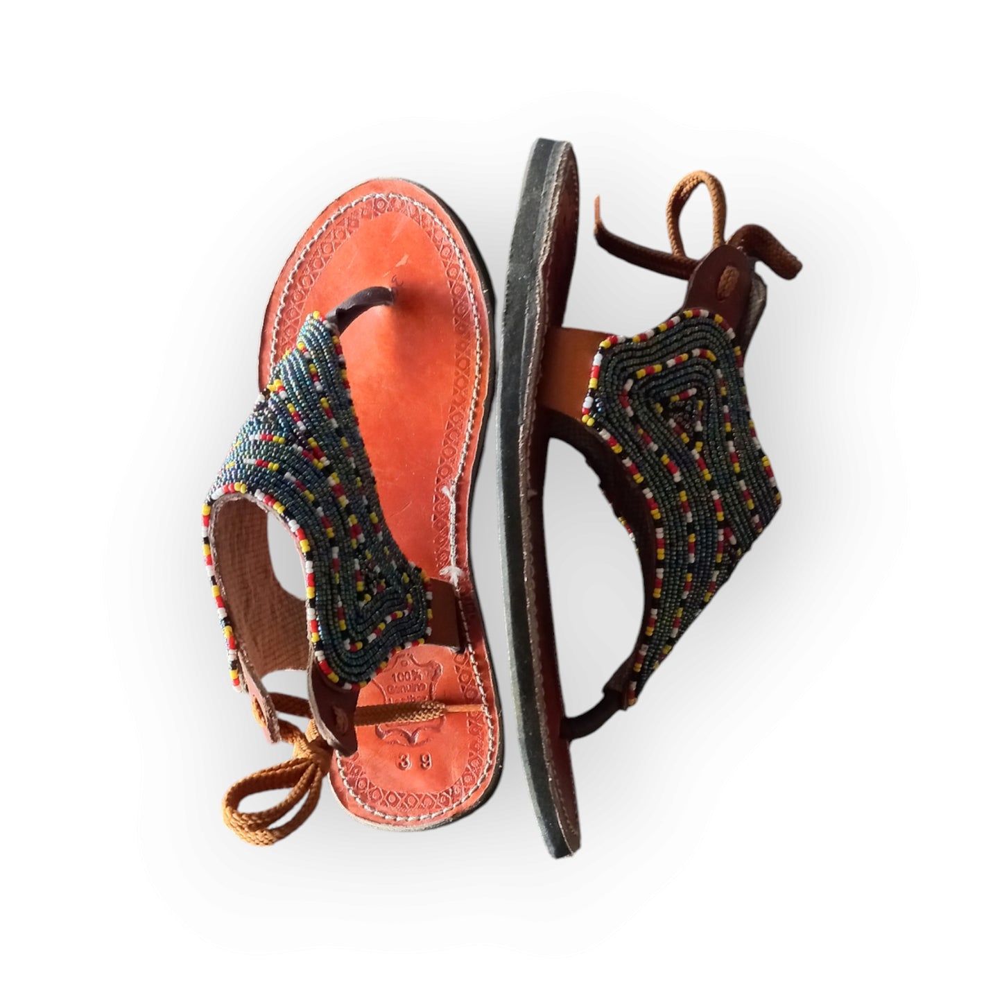 Handmade Maasai sandals with colorful beading and leather straps, made in Kenya.
