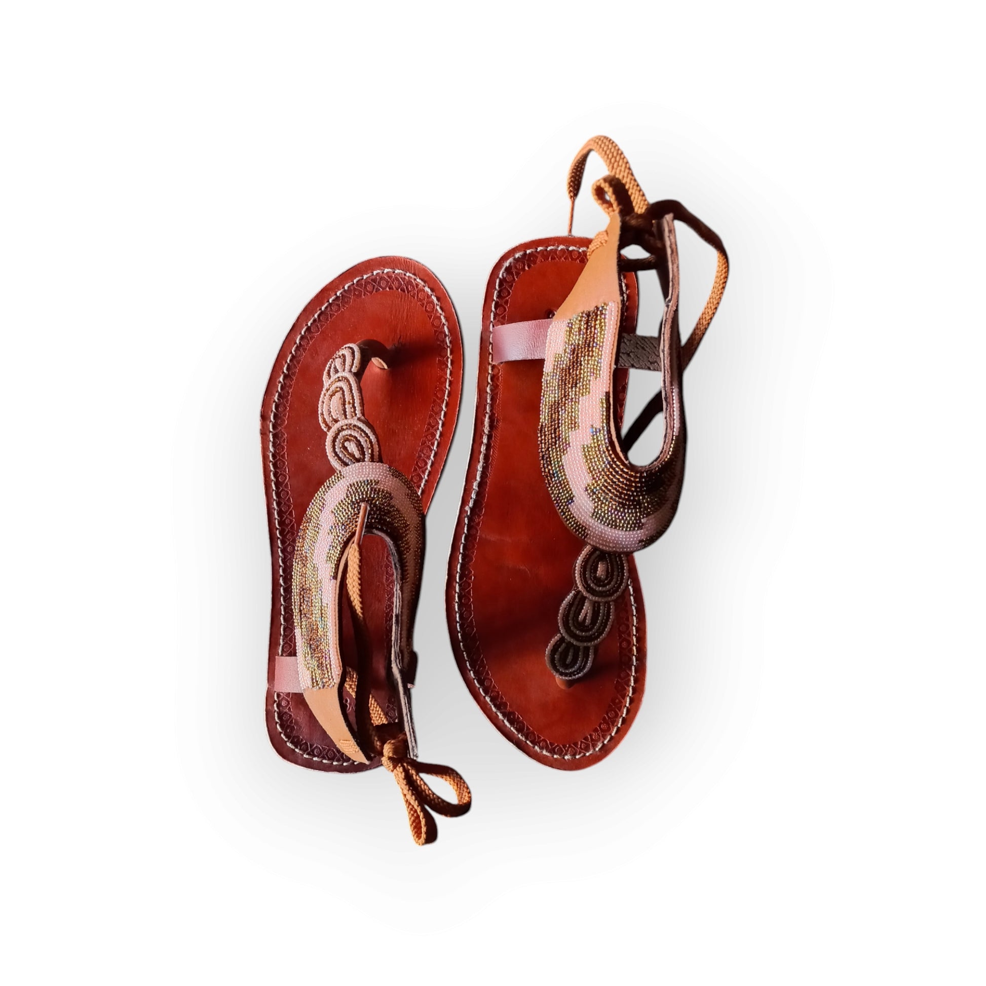 Handmade Maasai sandals with colorful beading and leather straps, made in Kenya.
