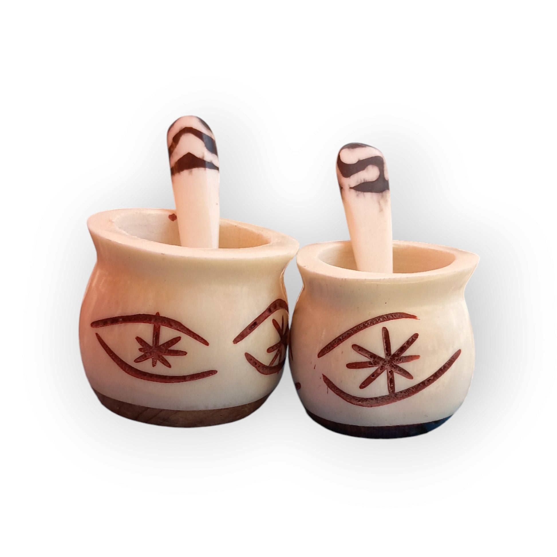 a pair of spice pots with an intricate geometric pattern and a wooden base. Handmade in Kenya   