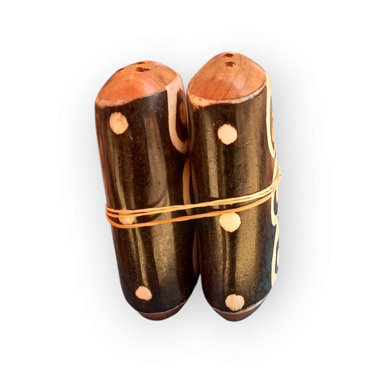Kenyan handcrafted camel bone salt and pepper shakers set with unique dark finish, swirl patterns, and dot details