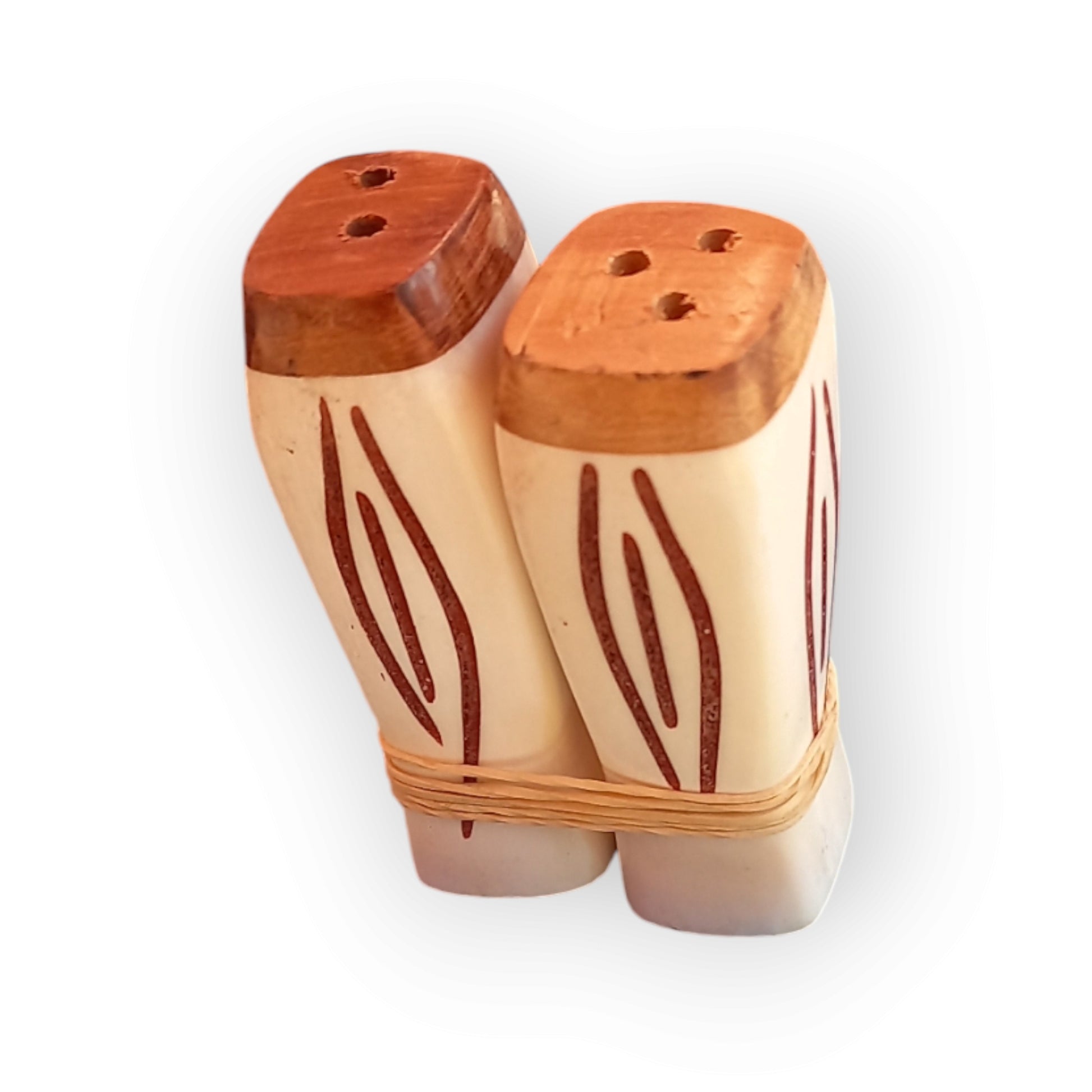 A pair of white cow salt & pepper shakers with a geometric pattern. Handmade in Kenya  