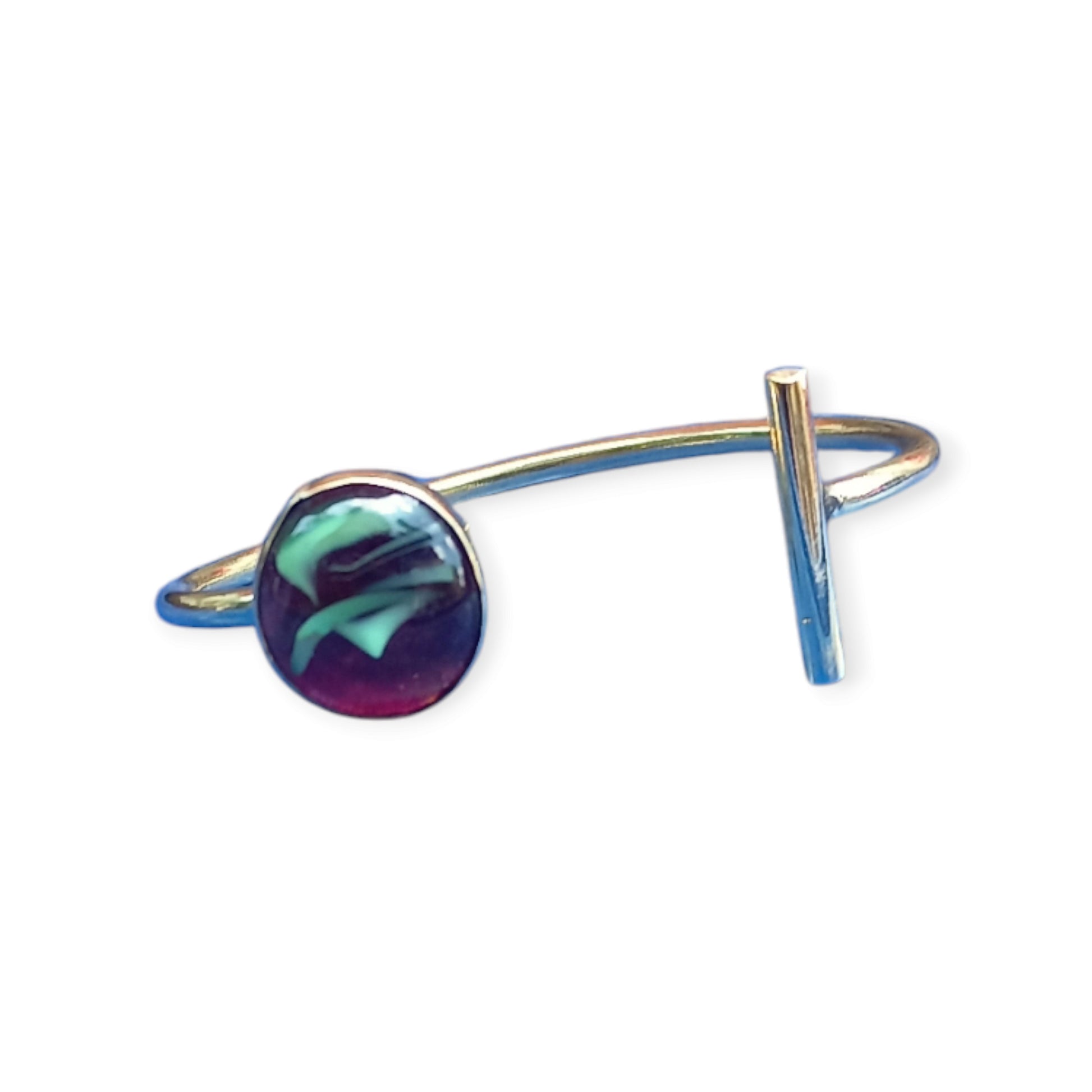 adjustable open cuff bracelet made of polished brass from Kenya, showcasing a single, abstract amber piece with rich internal details.