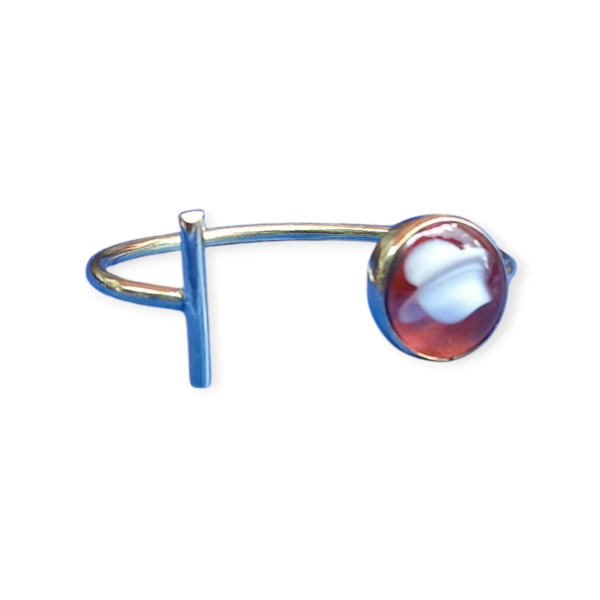 Handcrafted brass open cuff bracelet featuring a unique design with a circular patterned stone and a rectangular metal bar