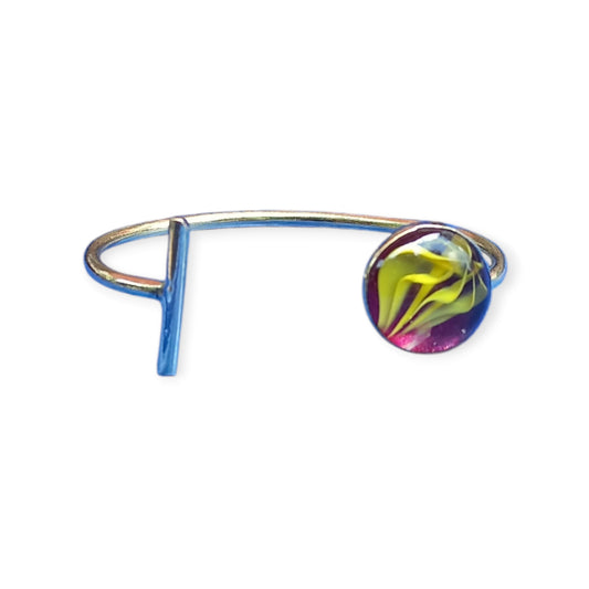 Artisan-made bracelet from Kenya with a smooth brass band and a captivating amber ornament with dynamic swirling patterns.