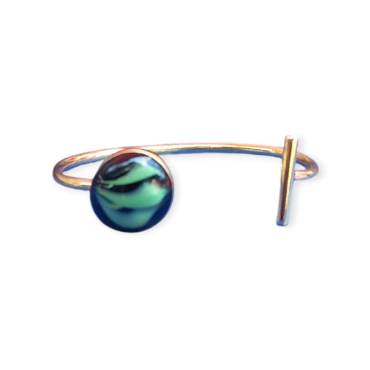Unique Kenyan brass cuff bracelet with a modern, artistic design, adorned with a one-of-a-kind teal and dark amber gemstone.