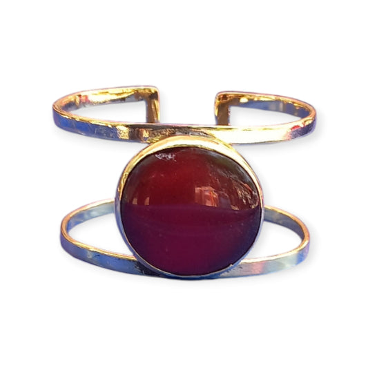 Handcrafted Kenyan brass cuff bracelet featuring a striking, large marron red amber ornament set in a unique double-band cuff.