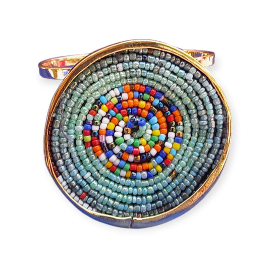 Adjustable open cuff bracelet made of polished brass from Kenya, showcasing a colorful, hand-beaded design