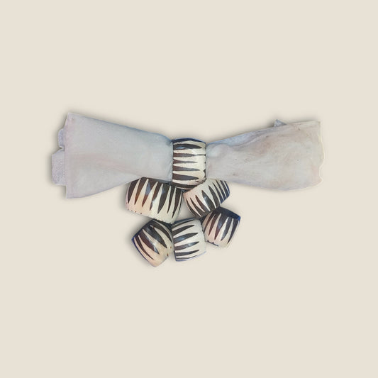 Kenyan handcrafted bone napkin rings set of 6 with unique zebra print design.