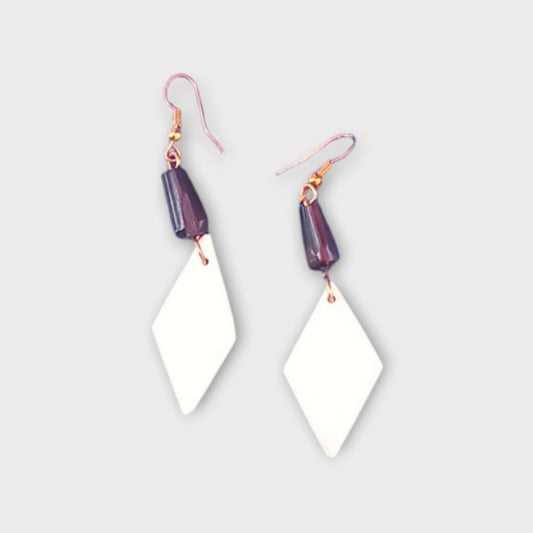  Handcrafted Kenyan earrings featuring a white diamond-shaped bone pendant and a dark accent bead.
