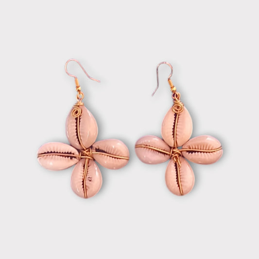 Elegant dangle earrings with a floral design made from small white cowrie shells, connected by delicate brass wire, made in Kenya.