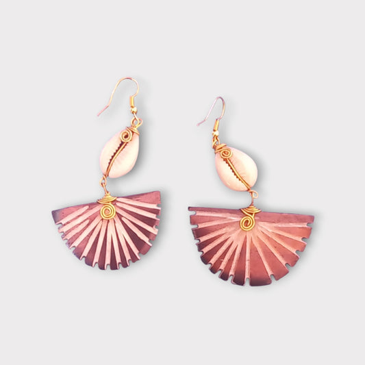 Made in Kenya dangle earrings with a natural cowrie shell and a textured, fan-like bone piece with deep carvings.