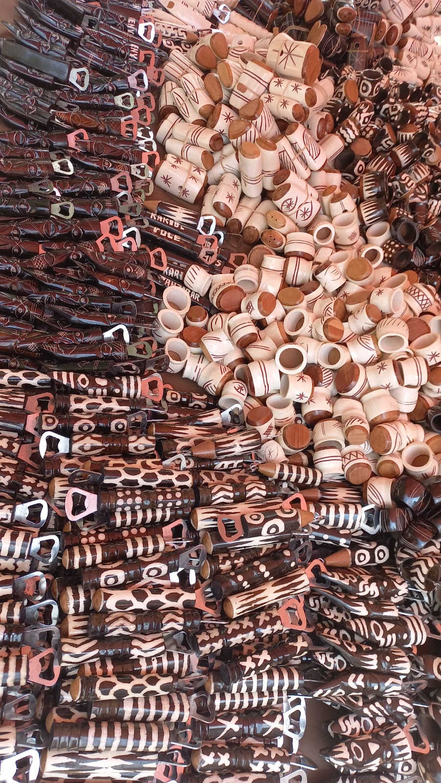 Assortment of traditional African carved wooden and bone bottle openers, shakers  unique handmade Kenyan souvenirs.