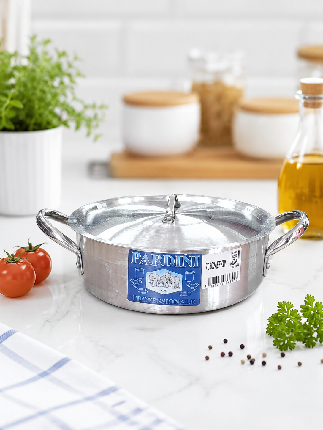 Pardini Professional shallow height aluminium casserole sufuria with stainless steel handles and lid manufactured by Kaluworks on a kitchen counter