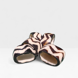 et of six handcrafted cow bone napkin rings with a black and cream zebra pattern, made in Kibera, Kenya.