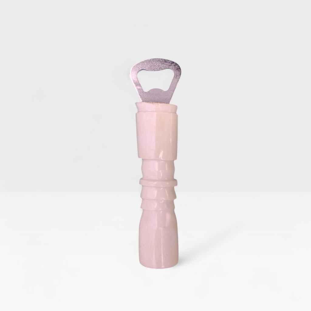 Handcrafted plain cow bone bottle opener with carved handle ridges made by Kibera artisans in Kenya