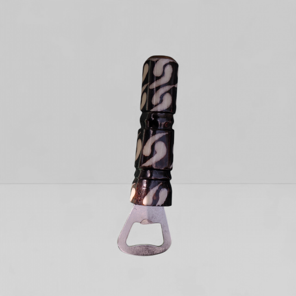 Handcrafted swirl batik cow bone bottle opener with black and ivory pattern made by Kibera artisans in Kenya